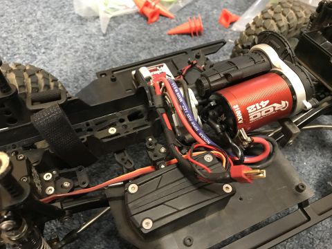 1989 Ford Bronco - Close-up of an RC car's internal components, including the motor and electronics.
