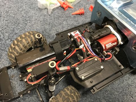 1989 Ford Bronco - Close-up of an RC car's internal components, including the motor and battery pack.