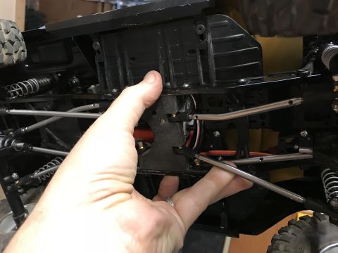 1989 Ford Bronco - Close-up view of the intricate undercarriage of a remote control vehicle, highlighting its mechanical components.