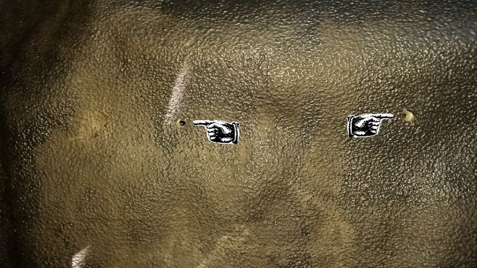 Here you can see the holes created by the hot welding rod.  The initial hole was quite small--only the diameter of the welding rod.  From inside the truck, I used the hot welding rod to expand the hole slightly to make lining up the screws a little easier.