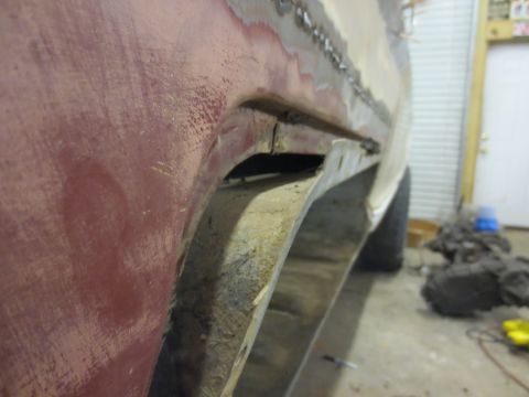 1967 Ford F-250 - Close-up view of the side of a 1967 Ford F-250, showing rust and repair work around the wheel well and fender area.