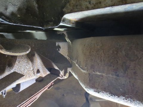 1967 Ford F-250 - Underside view of heavily rusted truck frame and leaf springs, indicating significant age and wear.