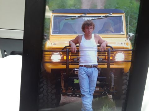 1994 Ford Bronco - A man poses in front of a yellow 1978 Ford Bronco.
