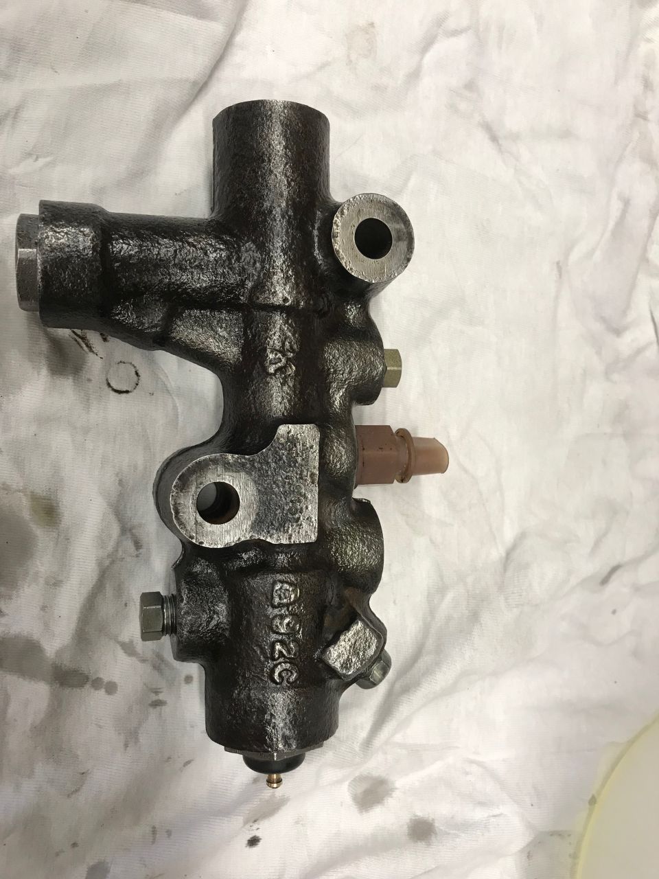 Dark metal brake master cylinder part with brown sensor