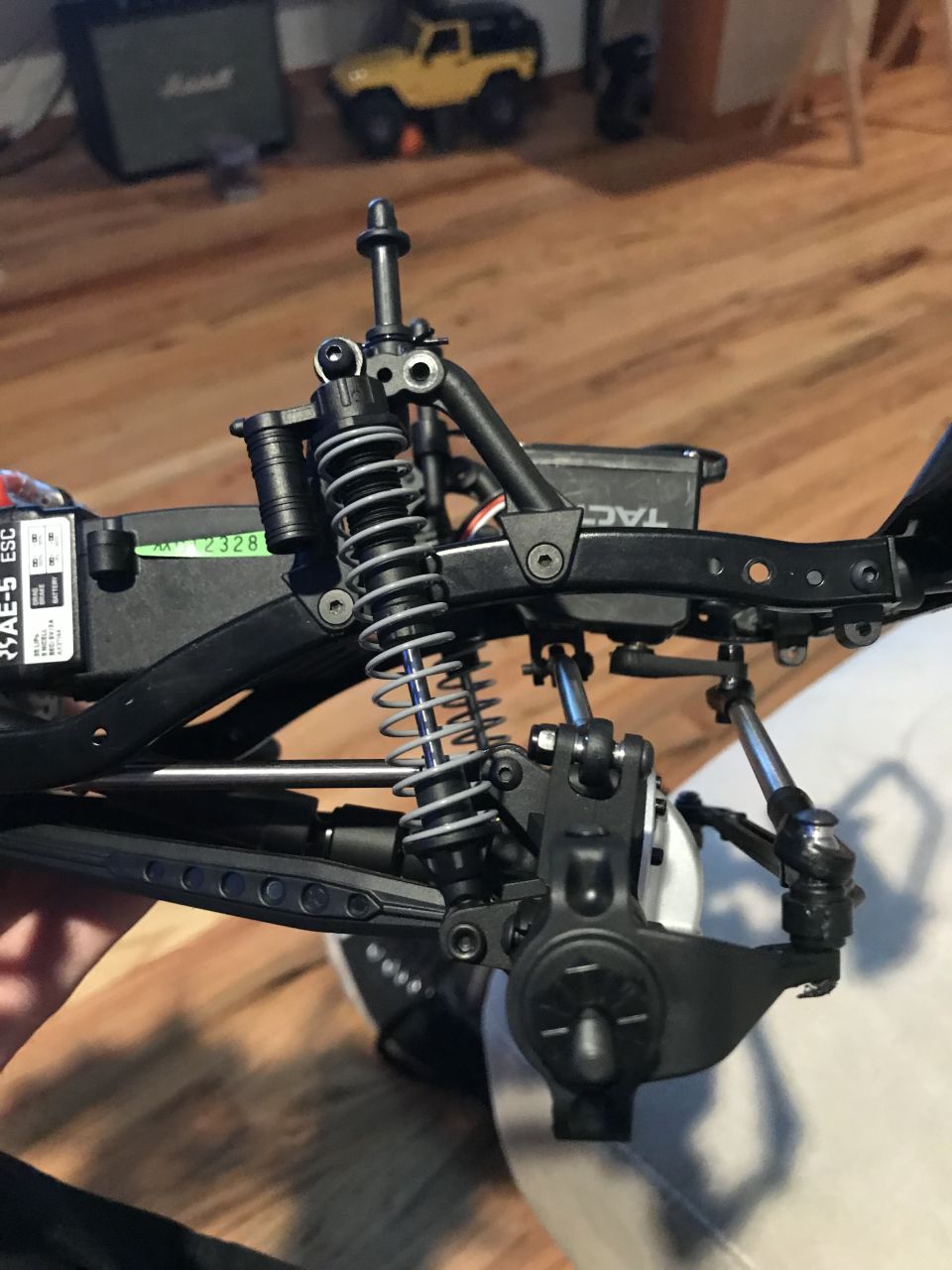 Remote control rock crawler chassis suspension and steering components.