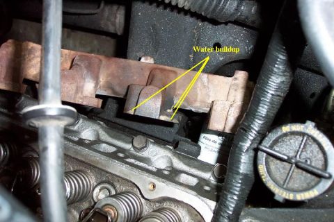 1992 Ford Bronco - Close-up of engine part showing water buildup and a filter. No vehicle year is visible.