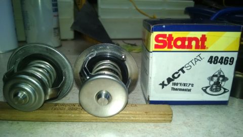 2008 Hyundai Accent - A Stant XACTSTAT 48469 thermostat is shown next to two other thermostats.
