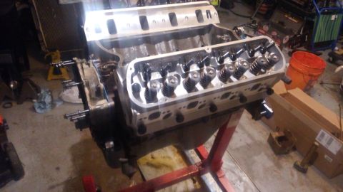 1988 Ford Bronco - Close-up view of a V8 engine block with internal components exposed, resting on an engine stand in a workshop.