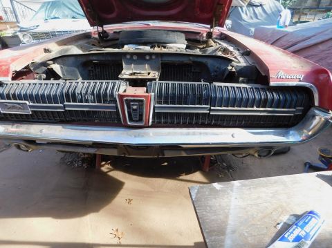 1968 Mercury Cougar - Front view of a 1968 Mercury Cougar with its hood open, revealing the grille and engine bay.