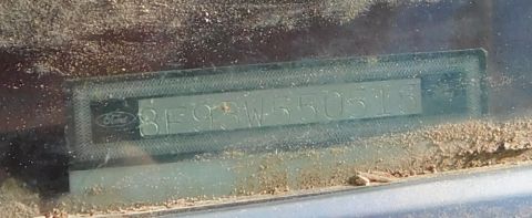 1968 Mercury Cougar - A vehicle identification number plate is visible through a dusty windshield.
