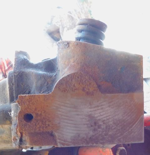 1968 Mercury Cougar - A heavily rusted engine component with a spring is shown in close-up, with visible machining marks on its surface.