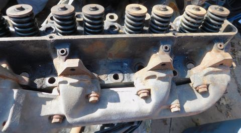 1968 Mercury Cougar - Close-up view of an engine cylinder head, showing valve springs and exhaust manifold attachment points.