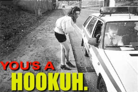 1991 Ford LTD Crown Victoria - A woman interacts with a police officer in a patrol car on a dirt road.