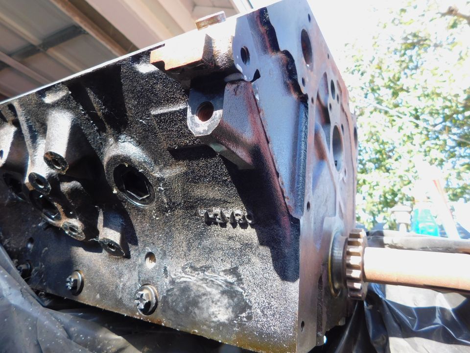Black engine block with visible casting numbers and a crankshaft snout