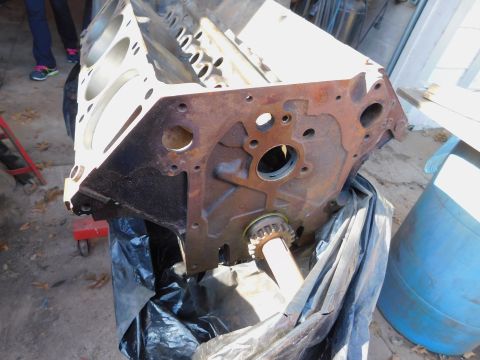 1968 Mercury Cougar - An engine block sits on a stand, partially covered by a black plastic bag.