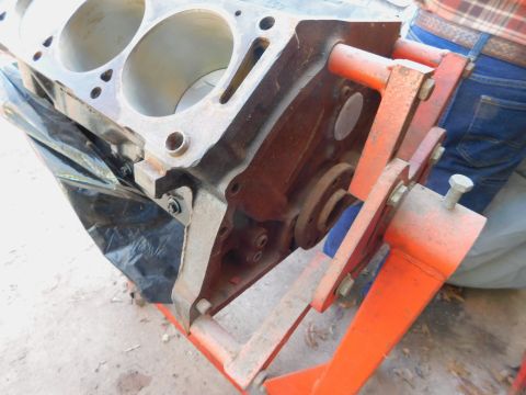 1968 Mercury Cougar - An engine block is mounted on an orange stand, revealing its internal cylinder structure and various bolts and brackets.