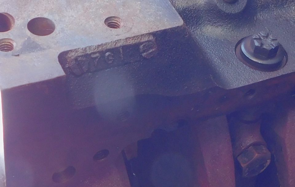 Close-up of engine block with stamped numbers '7612'