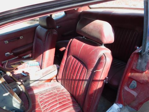 1968 Mercury Cougar - Interior view of a 1968 Mercury Cougar, red vinyl seats and door panels.