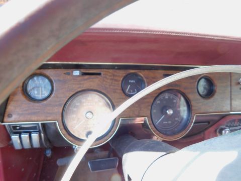 1968 Mercury Cougar - Interior view of a 1968 Mercury Cougar dashboard, multiple gauges and woodgrain trim.