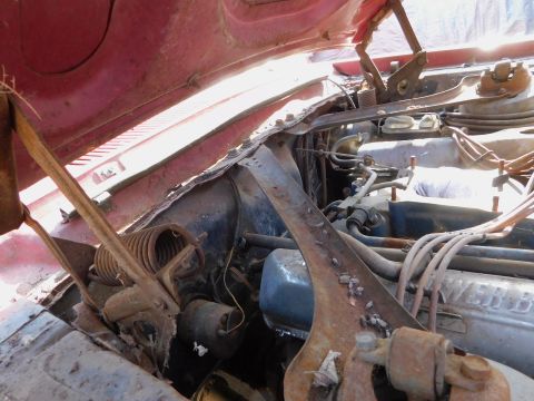 1968 Mercury Cougar - The engine bay of a vehicle, showing the V8 engine and various components under the hood.