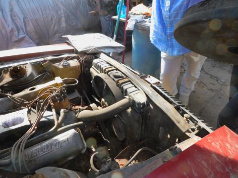 1968 Mercury Cougar - The engine bay of a red 1968 Mercury Cougar shows its V8 engine, radiator, and fan.