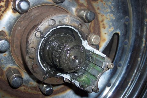 1973 Ford F-250 - Disassembled front wheel hub assembly showing extensive grease and wear.