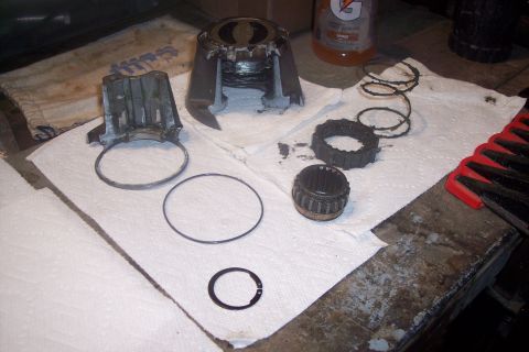 1973 Ford F-250 - Various components of a vehicle's hub assembly are spread out on a workbench for maintenance or repair.