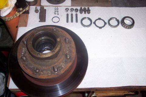 1973 Ford F-250 - Disassembled front hub and brake rotor components for a Ford F-250, including bearings and hardware.