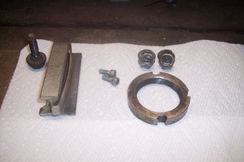 1973 Ford F-250 - Various automotive parts are arranged on a white paper surface, suggesting a repair or maintenance task.