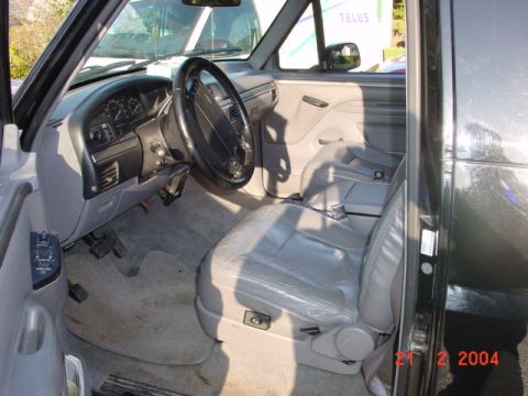 1995 Ford Bronco - The interior of a truck is shown, with a watermark indicating the photo was taken in 2004.
