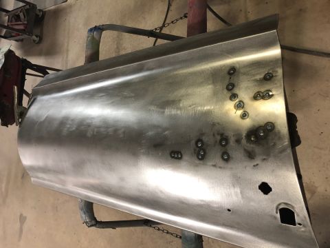 1968 Mercury Cougar - Bare metal car door panel shows evidence of repair work with multiple spot welds.
