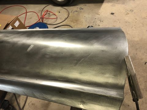1968 Mercury Cougar - A bare metal car door panel is prepped for work in a garage setting.