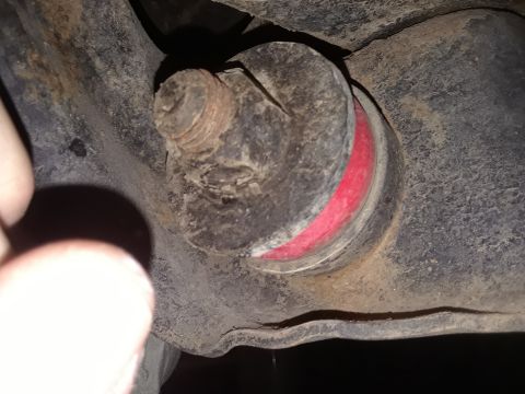 1985 Ford Bronco - This image shows a close-up view of a worn suspension bushing, likely from a vehicle's undercarriage.