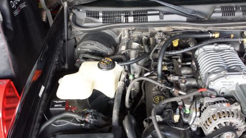 2005 Mercury Grand Marquis - Close-up view of a vehicle's engine bay, highlighting a supercharger installation.