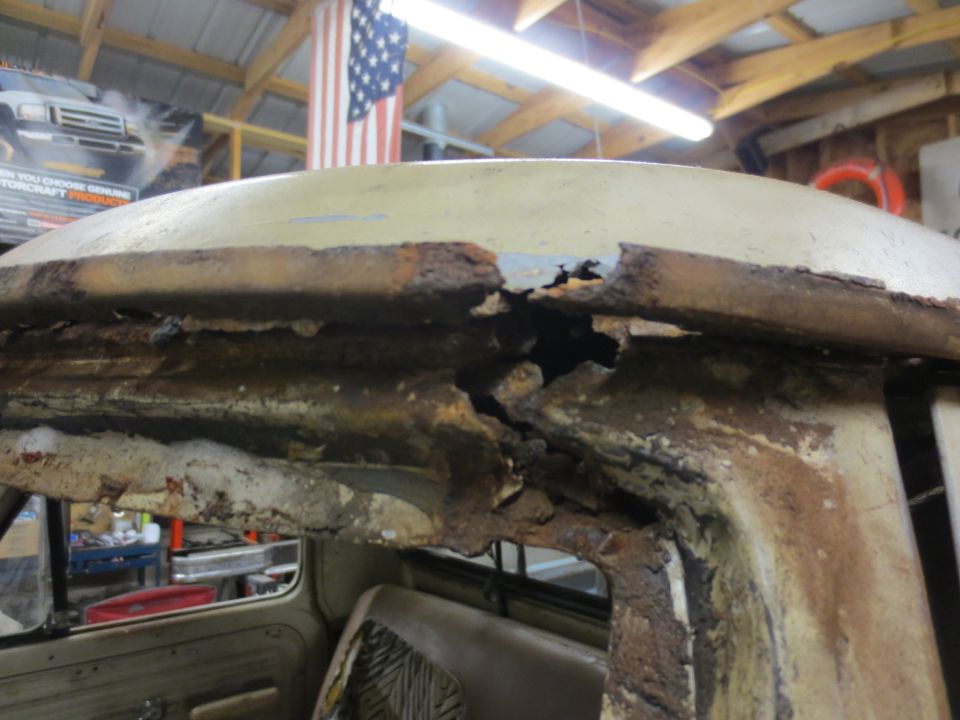 Close-up of severely rusted roof structure of a vintage pickup truck.
