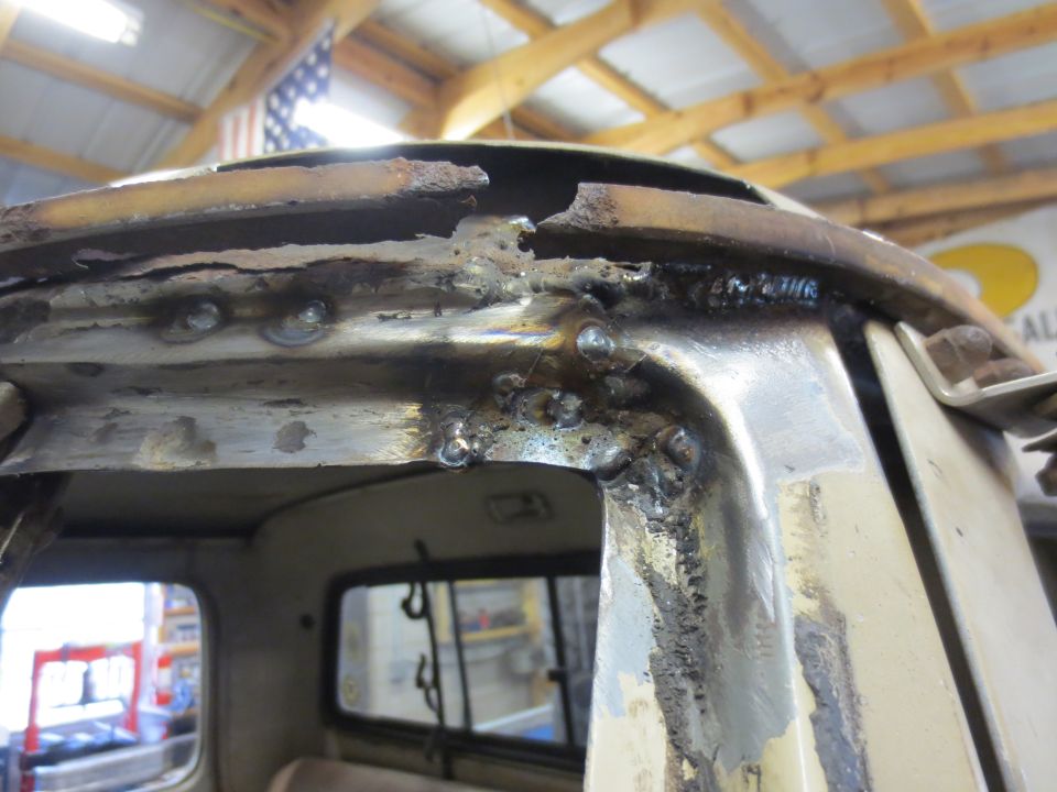 Rusted and welded roofline of a vintage pickup truck