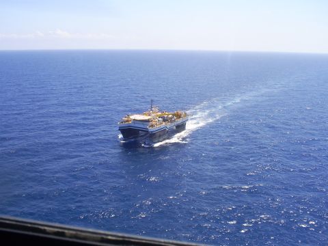 1992 Ford Bronco - An aerial view of a large, multi-decked vessel with a helideck moving through the ocean, leaving a white wake behind it.