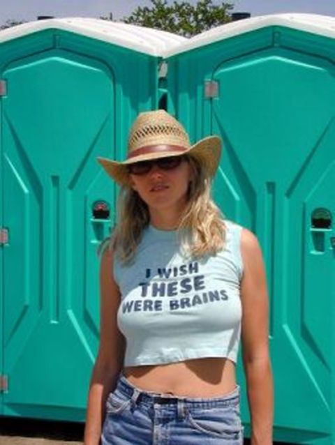 1979 Ford Bronco II - A woman poses in front of portable toilets, wearing a hat and a humorous t-shirt.
