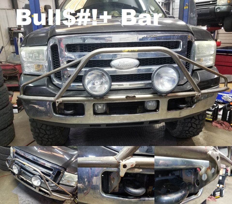 Bare steel tubular bull bar with round driving lights fitted to a dark Ford Super Duty front bumper