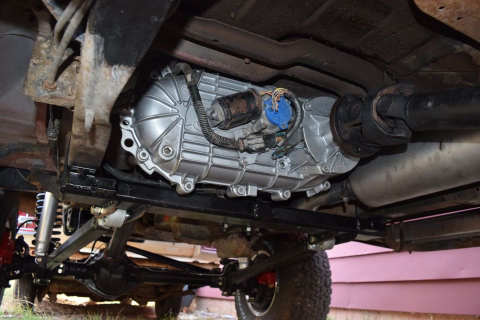 Underside of a 1995 Ford Bronco showing the transfer case and drivetrain components.