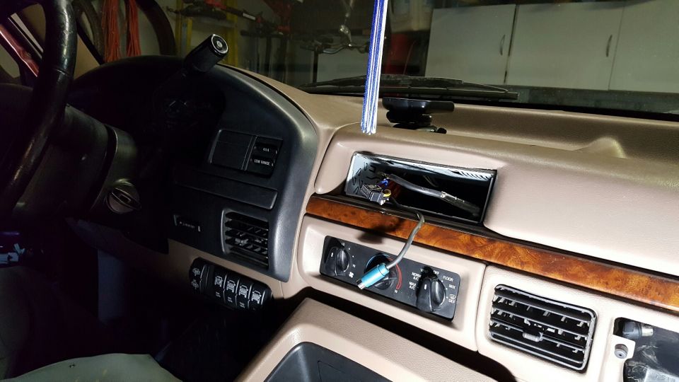 1996 Ford Bronco dashboard interior, showing removed radio, steering wheel, and climate controls.
