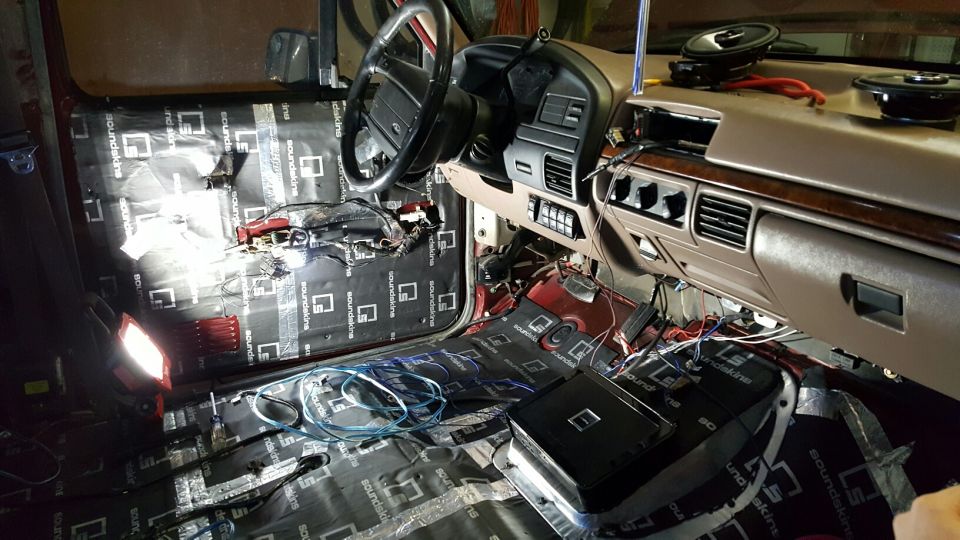 Interior of a 1996 Ford Bronco with sound deadening and audio system installation in progress.