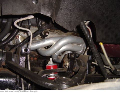 1978 Ford Bronco - This is a close-up view of the exhaust manifold and part of the suspension system of a vehicle.