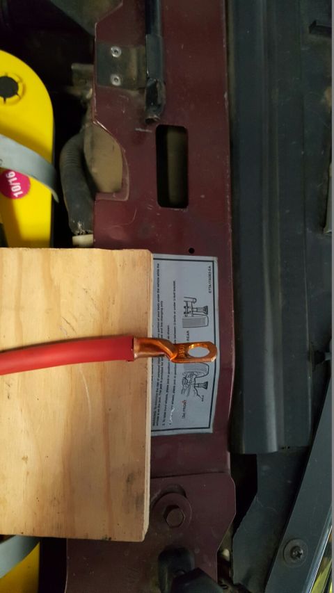 1996 Ford Bronco - Instruction sticker and battery cable shown in engine bay.