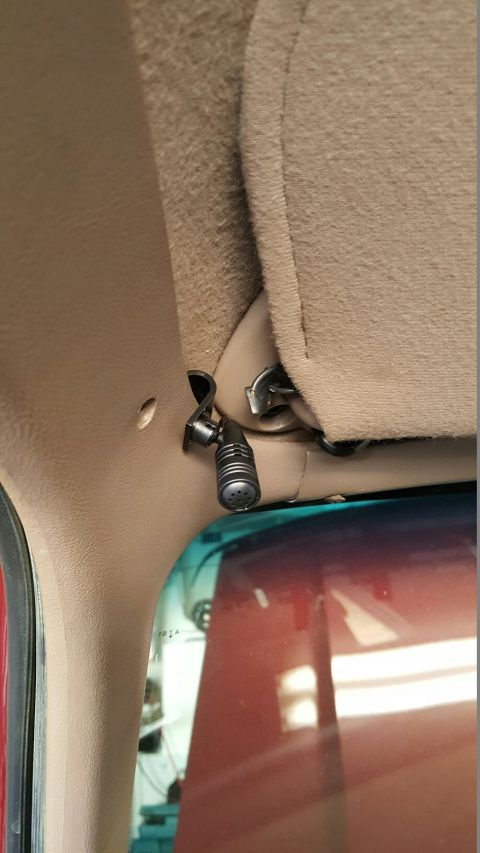 1996 Ford Bronco - A small microphone is attached to the interior headliner of a vehicle.