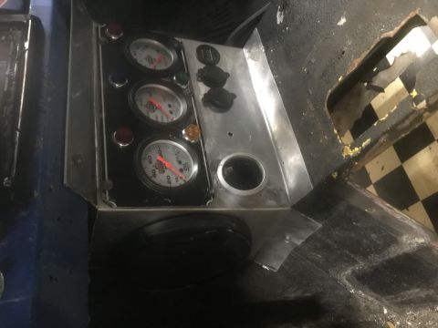 1974 Ford Bronco - Interior view of a custom dashboard three gauges and multiple power outlets.