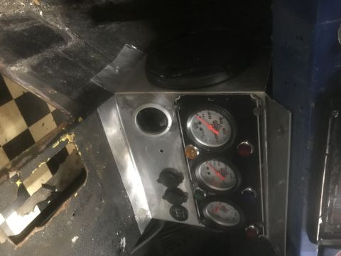 1974 Ford Bronco - Interior view of a vehicle's custom dashboard, showing gauges and switches.