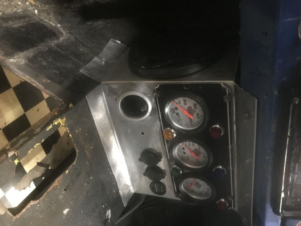 Custom dashboard with three gauges, indicator lights, and switches, viewed from above