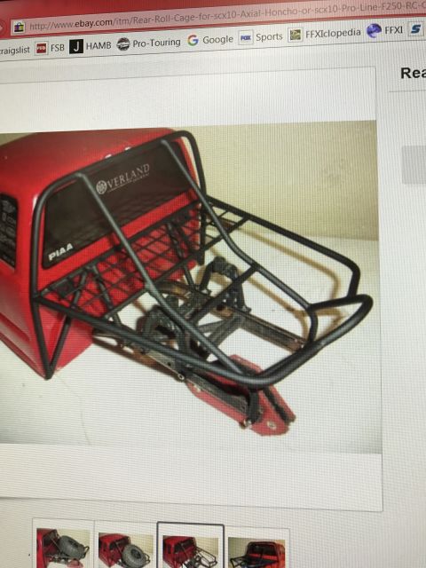 1989 Ford Bronco - This is a red RC truck bed with a black roll cage and PIAA and Overland decals visible.