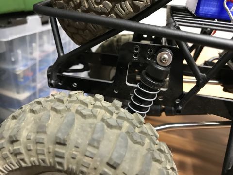 1989 Ford Bronco - The suspension and tires of a remote-control rock crawler are shown in detail.